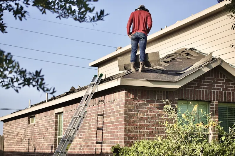 Professional roofer working on a residential roof in Russells Point